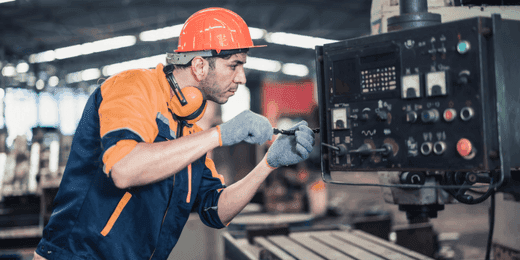 Worker checking the mechanical integrity of work equipment