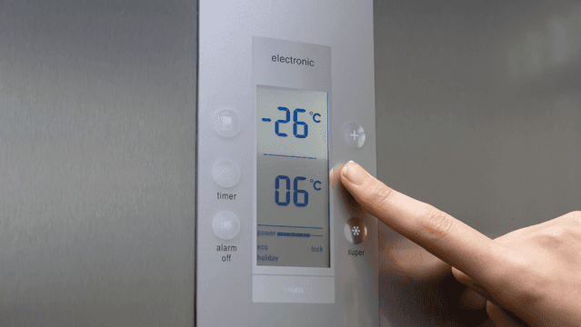 Staff setting up alarms with a temperature alarm response checklist