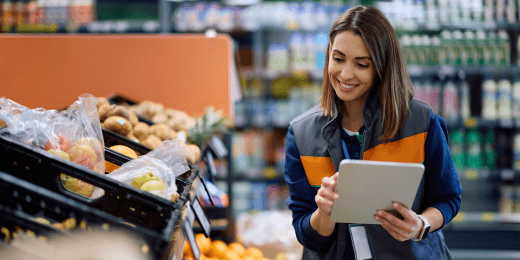 Grocery worker checking stock items based on ISO 22000 training