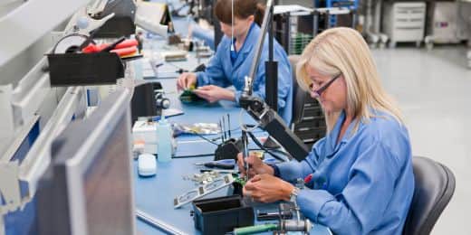 workers assembling parts of an electronic device while maintaining rohs compliance