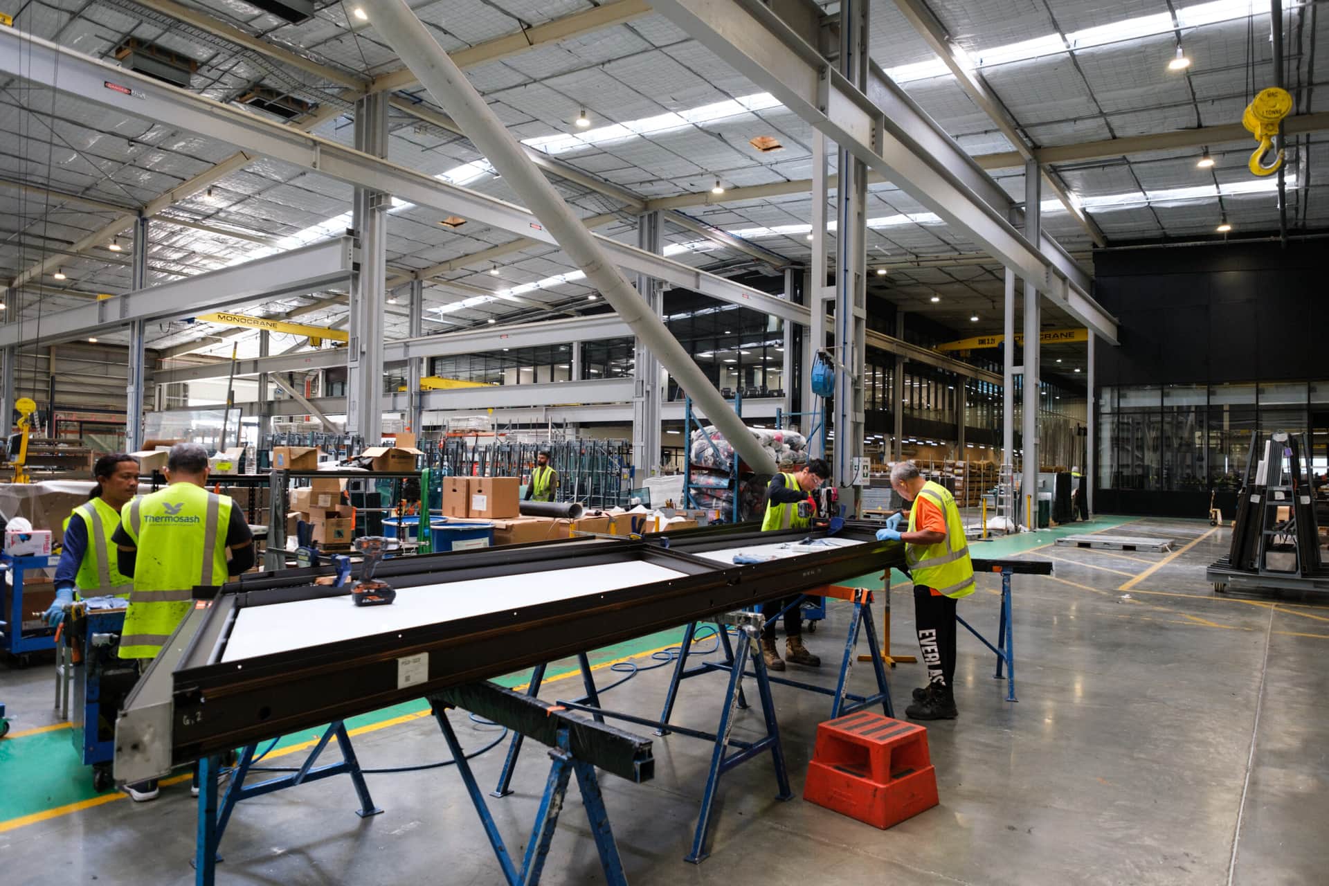 Thermosash Group manufacturing worker creating panels for bespoke building envelope | Image included in SafetyCulture manufacturing, construction, and installation case study