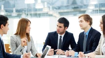 a group of senior leaders conducting a project initiation meeting