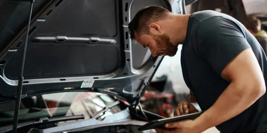 an inspector using a car fluids checklist